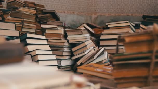 depositphotos_122469816-stock-video-stack-of-books-scattered-on.jpg