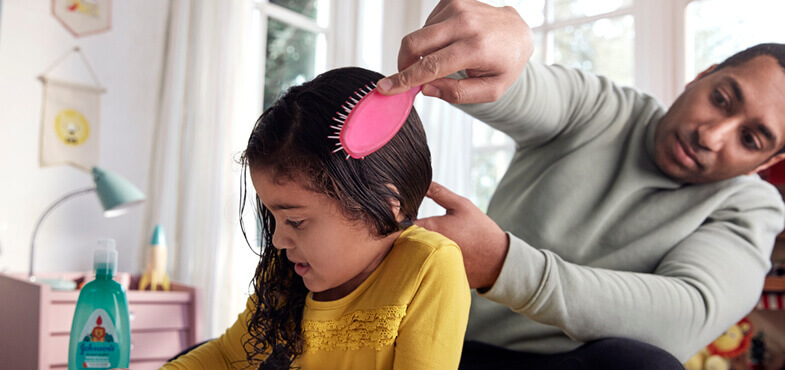 dad-brushing-daughter-hair-ar.jpg